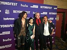 The actors embracing and smiling