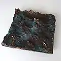 "Boot in bewegter See", 2019, bronze relief, 31 × 31 × 8&nbsp;cm