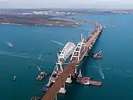 The installed arches of the bridge and the process of sliding the spans of the road bridge to the arch
