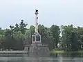 Side view shows an entrance leading into the base pedestal.