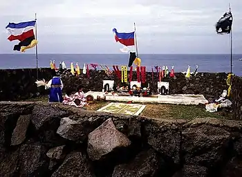 An outdoor shaman ritual, with several flags and banners.