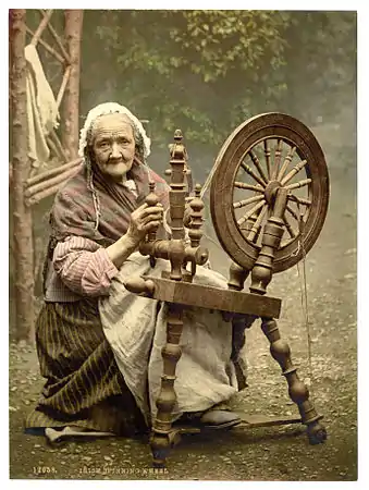 A photochrom of an elderly Irish woman using a spinning wheel, Co. Galway, Ireland, c. 1890s