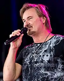 Nik P. performing in 2016