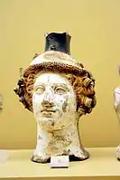 Terracotta vase in the shape of Dionysus' head, ca. 410 BC; on display in the Ancient Agora Museum in Athens, housed in the Stoa of Attalus