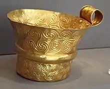 Gold cup from Mycenae decorated with triskelions, in the National Archaeological Museum of Athens.
