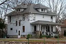 Image 11A wood-frame American Foursquare house in Minnesota with dormer windows on each side and a large front porch