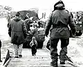A Korean toddler climbs the boarding ramp onto a C-54 at Kimpo
