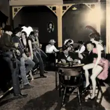 A staged photograph around opening week in 1961 with many of the park owners and associates. First man left is Ed Sutton forth man is Herbert Cowboy Coward, man in white hat is Uncle Dan Carpenter, lady in hat in back is Alaska Presley, man on right is Russell Pearson.