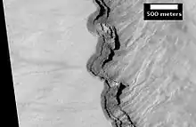 Close-up of layers in west slope of Asimov Crater.  Shadows show the overhang.  Some of the layers are much more resistant to erosion, so they stick out.  Image from HiRISE.