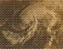 Black and white satellite image of a weakening tropical storm. The white represents clouds and the lines are country and state borders while the black represents land and water. The Gulf of Mexico is at the bottom of the image, with the spiraling hurricane situated over Louisiana. Most of the southern and central United States can be seen in the image.