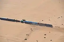 Track from Swakopmund to Walvis Bay covered by sand .mw-parser-output .geo-default,.mw-parser-output .geo-dms,.mw-parser-output .geo-dec{display:inline}.mw-parser-output .geo-nondefault,.mw-parser-output .geo-multi-punct{display:none}.mw-parser-output .longitude,.mw-parser-output .latitude{white-space:nowrap}22°47′17″S 014°35′20″E﻿ / ﻿22.78806°S 14.58889°E﻿ / -22.78806; 14.58889