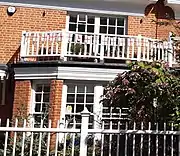 "small window panes, ... bay windows, wooden balconies"