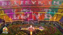 A set of rainbow-coloured placards read as "Believe in Love" in a stadium