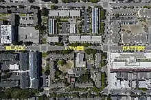 Aerial shot of three city blocks. The words "black," "lives," and "matter" are in all capitol letters, one word on the street per block.
