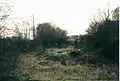 Blowers Green station forecourt in 2002. It has been fenced off since 2004 due to youths' anti-social behaviour, structural decay and periodical use by vagrants.