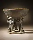 Bowl supported by 3 figures; 850–1500; resist-painted ceramic; height: 28.58&nbsp;cm (11.mw-parser-output .frac{white-space:nowrap}.mw-parser-output .frac .num,.mw-parser-output .frac .den{font-size:80%;line-height:0;vertical-align:super}.mw-parser-output .frac .den{vertical-align:sub}.mw-parser-output .sr-only{border:0;clip:rect(0,0,0,0);clip-path:polygon(0px 0px,0px 0px,0px 0px);height:1px;margin:-1px;overflow:hidden;padding:0;position:absolute;width:1px}1⁄4 in.), diameter of the bowl: 19.69&nbsp;cm (7.mw-parser-output .frac{white-space:nowrap}.mw-parser-output .frac .num,.mw-parser-output .frac .den{font-size:80%;line-height:0;vertical-align:super}.mw-parser-output .frac .den{vertical-align:sub}.mw-parser-output .sr-only{border:0;clip:rect(0,0,0,0);clip-path:polygon(0px 0px,0px 0px,0px 0px);height:1px;margin:-1px;overflow:hidden;padding:0;position:absolute;width:1px}3⁄4 in.); from Colombia; Los Angeles County Museum of Art (USA)