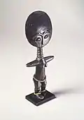 Doll (Akuaba); 20th century; 27.3 x 11.4 x 3.8&nbsp;cm (10.mw-parser-output .frac{white-space:nowrap}.mw-parser-output .frac .num,.mw-parser-output .frac .den{font-size:80%;line-height:0;vertical-align:super}.mw-parser-output .frac .den{vertical-align:sub}.mw-parser-output .sr-only{border:0;clip:rect(0,0,0,0);clip-path:polygon(0px 0px,0px 0px,0px 0px);height:1px;margin:-1px;overflow:hidden;padding:0;position:absolute;width:1px}3⁄4 x 4.mw-parser-output .frac{white-space:nowrap}.mw-parser-output .frac .num,.mw-parser-output .frac .den{font-size:80%;line-height:0;vertical-align:super}.mw-parser-output .frac .den{vertical-align:sub}.mw-parser-output .sr-only{border:0;clip:rect(0,0,0,0);clip-path:polygon(0px 0px,0px 0px,0px 0px);height:1px;margin:-1px;overflow:hidden;padding:0;position:absolute;width:1px}1⁄2 x 1.mw-parser-output .frac{white-space:nowrap}.mw-parser-output .frac .num,.mw-parser-output .frac .den{font-size:80%;line-height:0;vertical-align:super}.mw-parser-output .frac .den{vertical-align:sub}.mw-parser-output .sr-only{border:0;clip:rect(0,0,0,0);clip-path:polygon(0px 0px,0px 0px,0px 0px);height:1px;margin:-1px;overflow:hidden;padding:0;position:absolute;width:1px}1⁄2 in.); Brooklyn Museum (New York City)