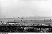 Shell splashes in the waters off Riva Bella (Sword Beach), May 30, 1944.