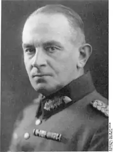 A man with short hair combed back wearing a military uniform.