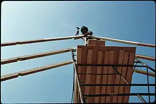 Pipe staging is very common in the U.S. Welded sections stack on top of each other and braced with cross braces, workers stand on planks or aluminum platforms.