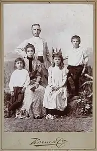 Studio portrait of an Indo-European family, Dutch East Indies (ca. 1900)