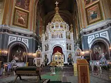 An ornate altar surrounded by several iconographic depictions of saints.