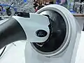 Black release button on a SAE J1772 plug in a mockup car