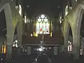 Stained glass windows flanked by the organ pipes
