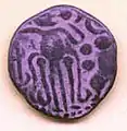 A copper coin of Rajaraja Chola with a Tiger besides the human figure