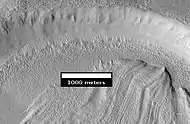 Concentric Crater Fill Close-up of near the top of previous image, as seen by HiRISE.  The surface debris covers water ice.