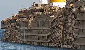 Starboard side of the righted Costa Concordia, showing the crushing impact of the rock spurs upon which it rested.
