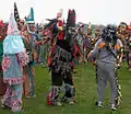 A "Miter" wearing Mardi Gras dancing in a yard