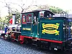A green steam locomotive with a 2-4-4T wheel arrangement and no tender