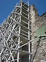 Wooden pole scaffold.