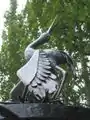 Stork sculpture of wrought "Tree of life" composition