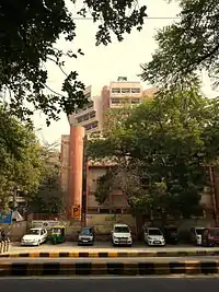 alt=Building with
trees and parked cars