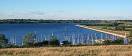 A lake with pleasure craft docked in the foreground
