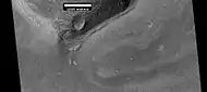 Wide view of a cliff and remains of a glacier, as seen by HiRISE under HiWish program.