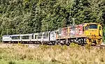 AK carriages being pulled by a DX class locomotive