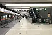 Eastbound line 6 platform with escalator to exits A, E, and H to the right