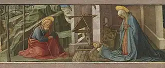 A baby with a halo around his head lying on hay with a kneeling woman and man on his both sides