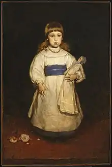 young girl standing with blue sash.