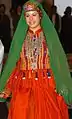 GI walks down the runway during a fashion show dressed in a colorful, traditional Afghan dress. The March 3, 2008