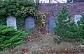 semi-circular brick wall, left side with gravestones