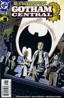 Five police officers on a rooftoop, standing in front of the 'Bat signal' searchlight