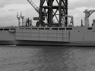 A Mexeflote suspended from the starboard flank of HMAS&nbsp;Choules