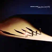 All four band members (from L to R: Caleb, Kieran, Peppa, Ashton) wearing black, standing on a sand dune lit up from the right, with Caleb holding a circular mirror reflecting light towards the camera.