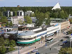 Ahjo building from 1935 in central Hyvinkää. The church of Hyvinkää in the background.