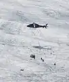 Transport of the equipment to the Morteratsch Glacier by a helicopter.