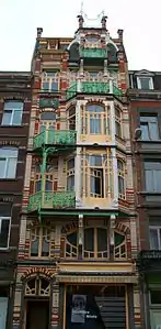 Asymmetric facade with curved lines of De Beck building by Gustave Strauven in Brussels (1905)